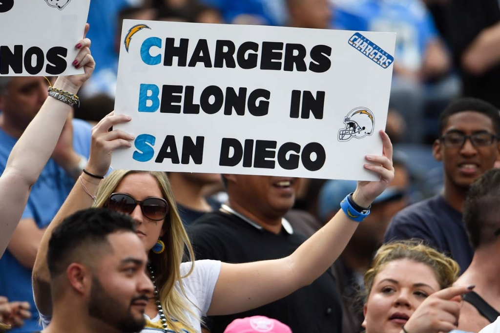 San Diego Chargers fan holds a sign against the team's relocation during the first half of an NFL football game against the Oakland Raiders in San Diego