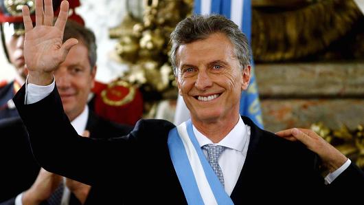 Argentina's President Mauricio Macri waves after being sworn-in as president at Casa Rosada Presidential Palace in Buenos Aires Argentina