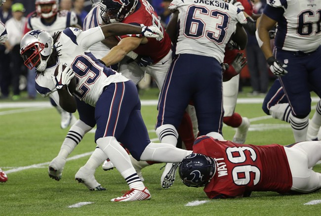 New England Patriots running back Le Garrette Blount is stopped by Houston Texans defensive end J.J. Watt during the first half of an NFL football game Sunday Dec. 13 2015 in Houston