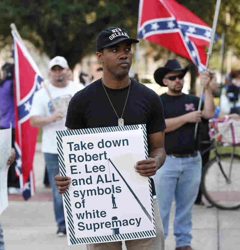 People demonstrate for and against the Confederate monuments in front of City Hall this month