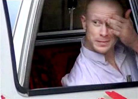 In this image made from video obtained from Voice Of Jihad Website which has been authenticated based on its contents and other AP reporting Sgt. Bowe Bergdahl sits in a vehicle guarded by the Taliban in eastern Afghanistan. The popular podcast “Seri