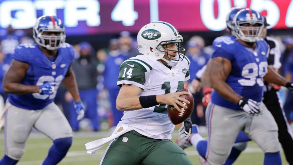 New York Jets quarterback Ryan Fitzpatrick rushes during the second half of an NFL football game against the New York Giants