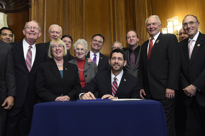 House Speaker Paul Ryan of Wis. prepares to sign legislation on Capitol Hill in Washington Wednesday Dec. 9 2015 that changes how the nation's public schools are evaluated rewriting the landmark No Child Left Behind education law of 2002. (AP