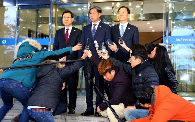 Hwang Boogi center South Korea's vice minister of unification and the head negotiator for high-level talks with North Korea speaks to the media before leaving for Kaesong at the office of inter Korean Dialogue in Seoul South Korea Friday Dec. 11 2