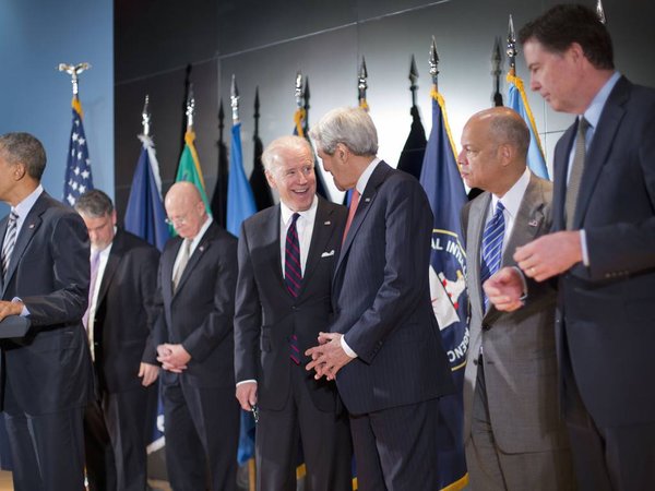 Vice President Joe Biden smiles and talks to Secretary of State John Kerry center at the National Counterterrorism Center in McLean Va.,Thursday Dec. 17 2015. President Barack Obama far left met with members of his national security team. From lef