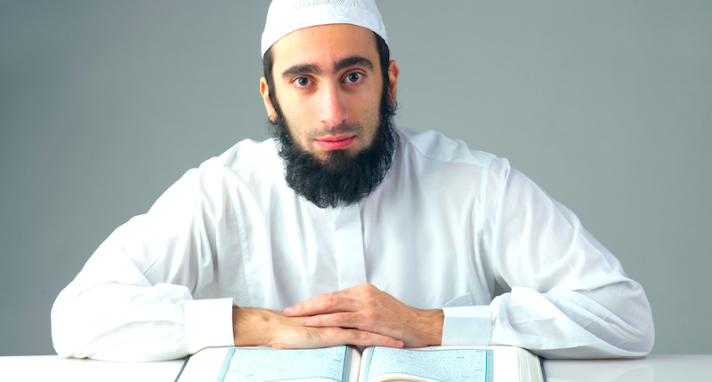 Muslim man cleric or imam studying Koran