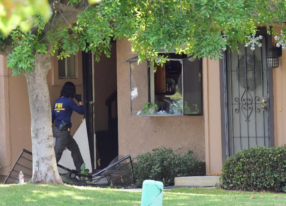 A member of an FBI evidence response team enters the home of San Bernardino shooters Syed Farook and Tashfeen Malik in Redlands California