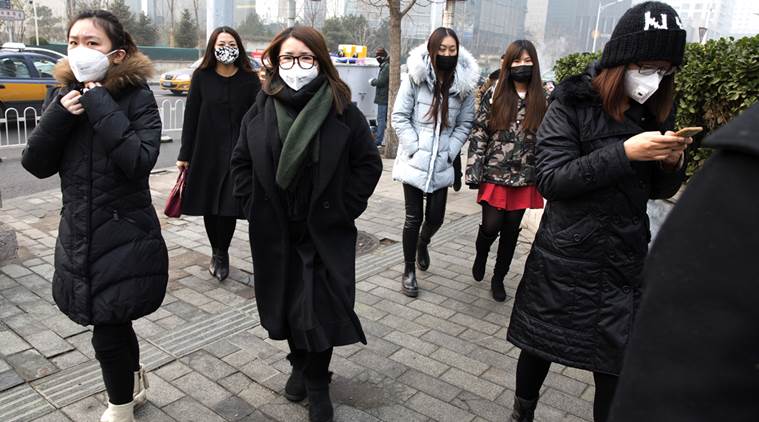 Office workers wear masks for protection against the pollution in Beijing China Wednesday Dec. 9 2015