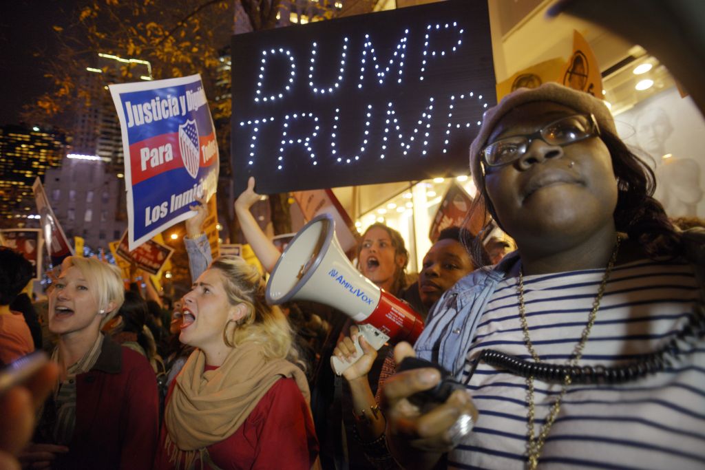 Sasha Murphy of the ANSWER Coalition leads demonstrators in a chant during a protest against Republican presidential candidate Donald Trump's hosting 'Saturday Night Live&#039 in New York