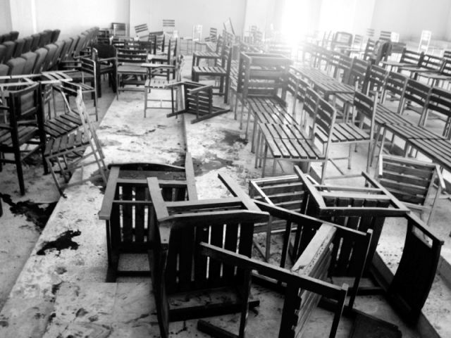 Overturned tables and chairs in a classroom at the Taliban-stricken Army Public School