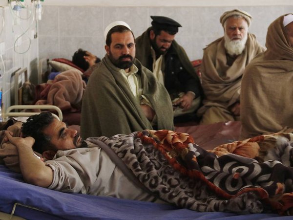 Family members sit near a man injured in an earthquake at a hospital in Peshawar Pakistan Saturday Dec. 26 2015. A strong earthquake shook parts of Pakistan and Afghanistan early Saturday rattling buildings and forcing sleeping residents out of their