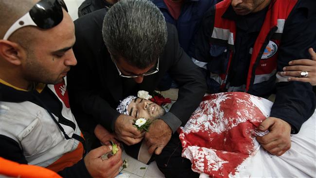 Medics and relatives of 23-year-old Bilal Zayed who was killed during clashes with Israeli forces trying to raid the Qalandiya refugee camp near the city of Ramallah in the occupied West Bank bid farewell to the victim at the camp