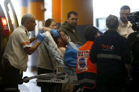 Israeli medics evacuate an Israeli man injured by what Israeli military's initial report said was a Palestinian stabbing attack in the West Bank at a hospital in Jerusalem