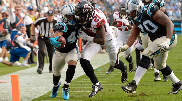 CHARLOTTE NC- DECEMBER 13 Fozzy Whittaker #43 of the Carolina Panthers extends the ball across the goal line against Desmond Trufant #21 of the Atlanta Falcons in the 3rd quarter during their game at Bank of America Stadium