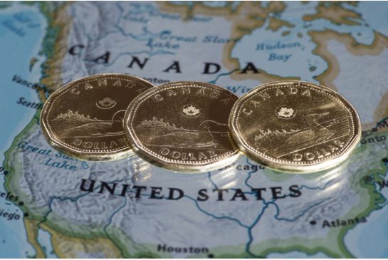 The Canadian dollar dropped to an 11-year low Monday as the price of crude oil futures fell