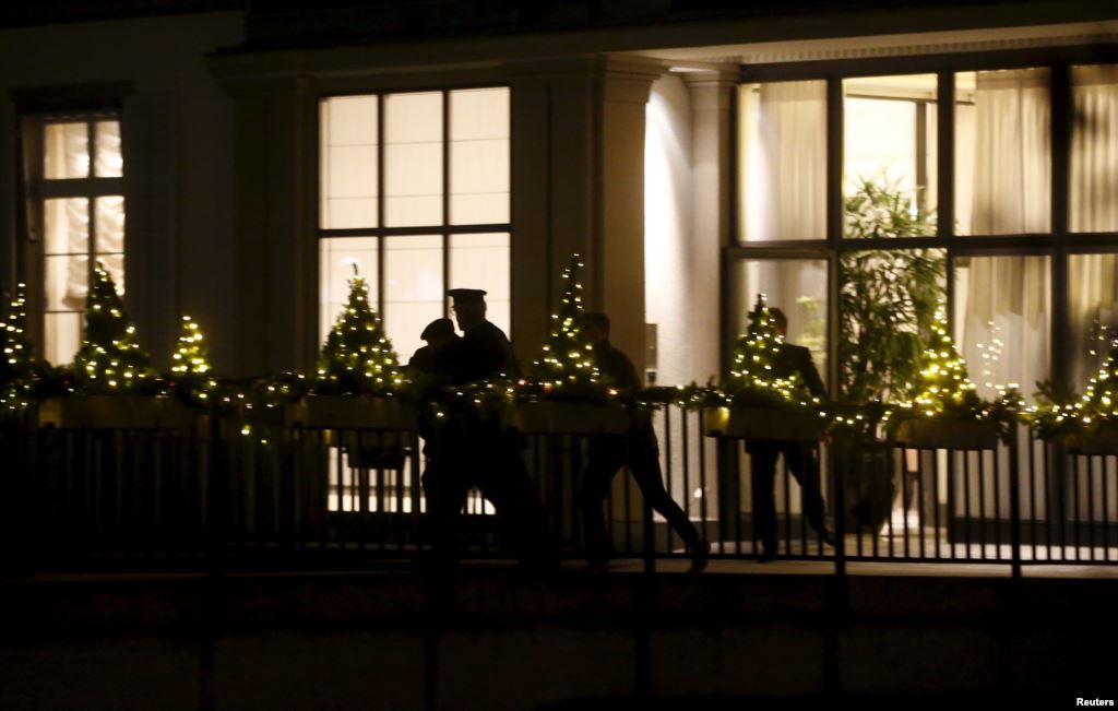 People are silhouetted outside the Baur au Lac hotel where Swiss police arrested FIFA officials in Zurich Switzerland Dec. 3 2015