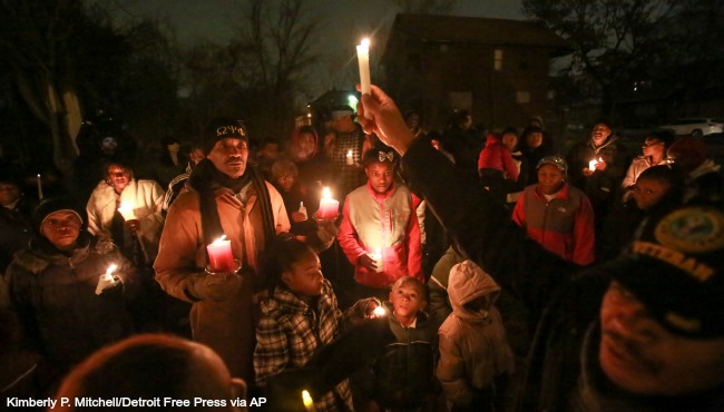 People gather during the candlelight vigil for Xavier Strickland on Saturday Dec. 5 2015 in Detroit