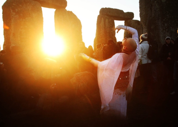 People gather for sunrise during winter solstice at Stonehenge in Wiltshire