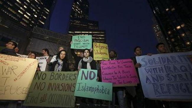 People take part in an anti Donald Trump pro-immigration protest in New York City on Thursday