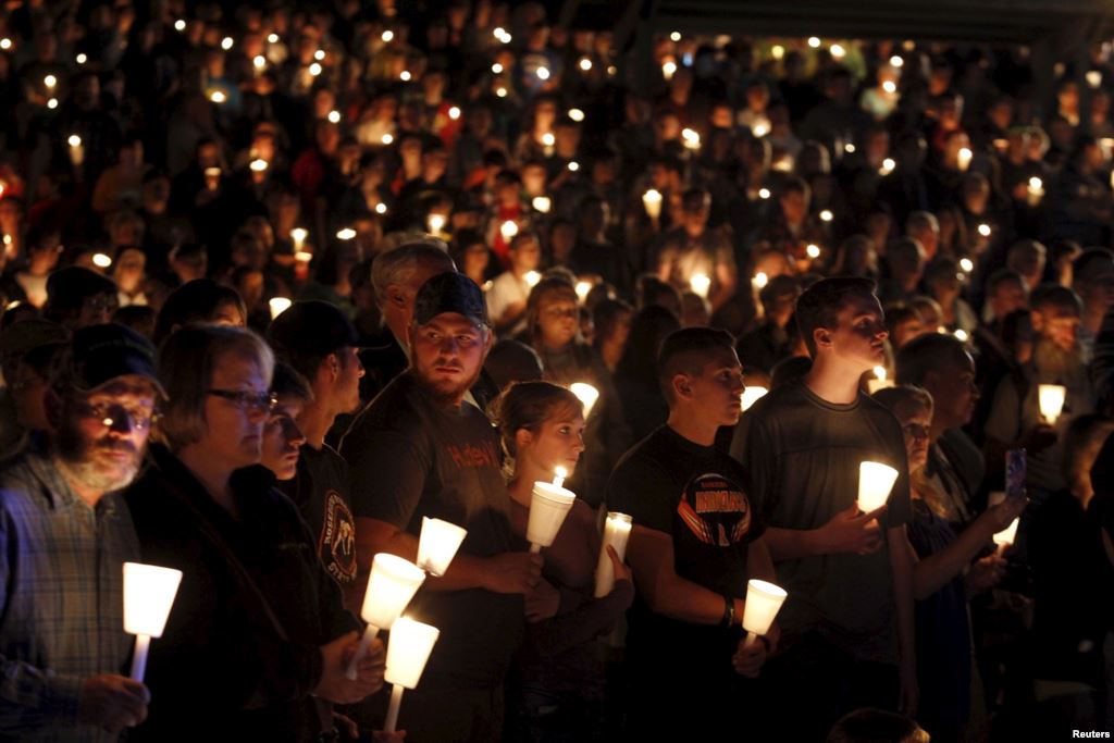 People take part in candlelight vigil following a mass shooting at Umpqua Community College in Roseburg Oregon Oct. 1 2015