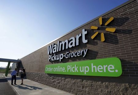 People talk outside a Wal Mart Pickup-Grocery test store in Bentonville