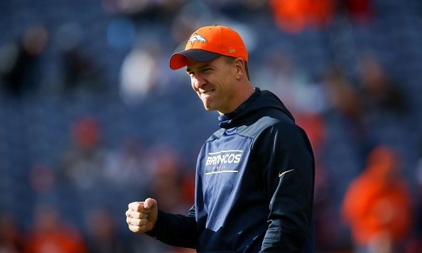 DENVER CO- DECEMBER 13 Quarterback Peyton Manning #18 of the Denver Broncos who was not suited up walks on the field during player warm ups before a game against the Oakland Raiders at Sports Authority Field at Mile High