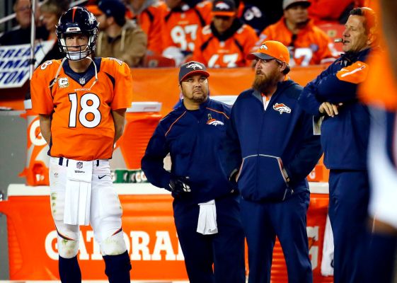 Denver Broncos quarterback Peyton Manning watches from