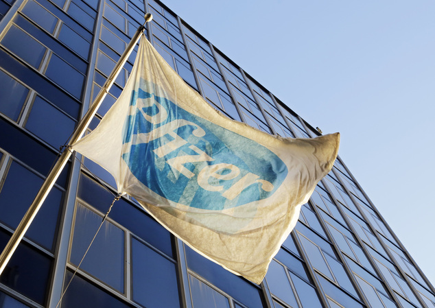 The Pfizer flag flies in front of world headquarters Monday Nov. 23 2015 in New York. Pfizer and Allergan will join in a $160 billion deal to create the