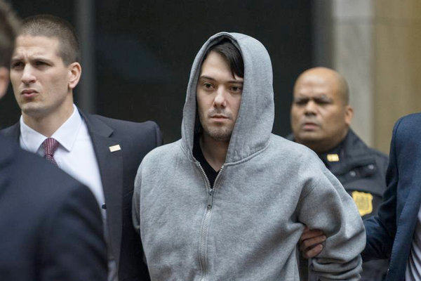 Martin Shkreli the former hedge fund manager under fire for buying a pharmaceutical company and ratcheting up the price of a life-saving drug is escorted by law enforcement agents in New York after being taken into custody following a securities probe