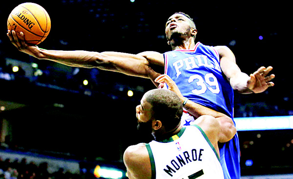 Philadelphia 76ers’ Jerami Grant shoots against Milwaukee Bucks’ Greg Monroe during the first half of an NBA basketball game Dec 23 in Milwaukee