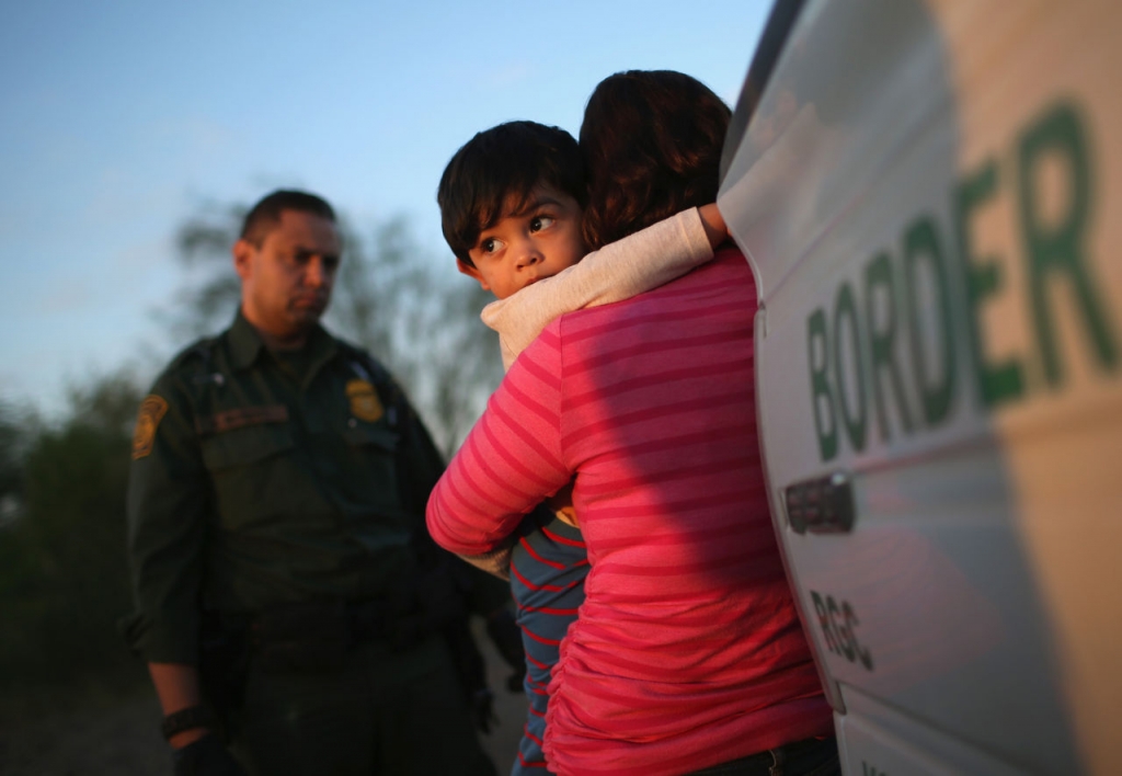 A one-year-old from El Salvador clings to his mother after she turned themselves in to Border Patrol agents on December 7 near Rio Grande City Texas. The mother said she brought her son on the 24-day journey from El Salvador to escape violence in the Cen