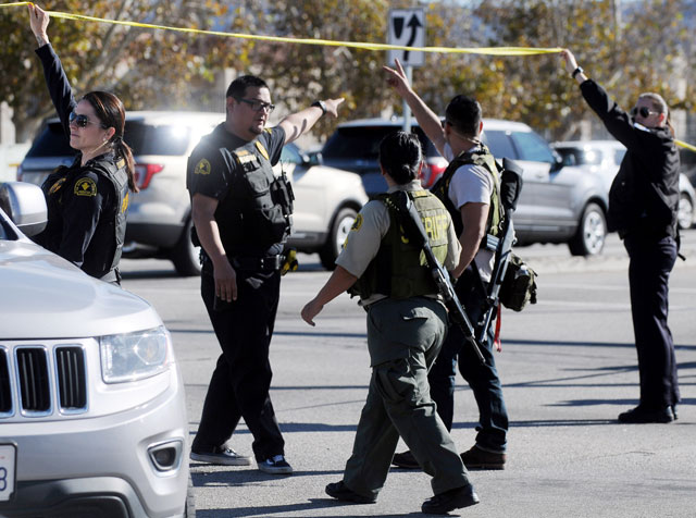 Deputies and officers from several law enforcement agencies work the scene of a mass shooting that killed 14 people and wounded more than a dozen others in San Bernardino Calif. on Wednesday Dec. 2 2015. (James Quigg  The Victor Valley Daily Press via A