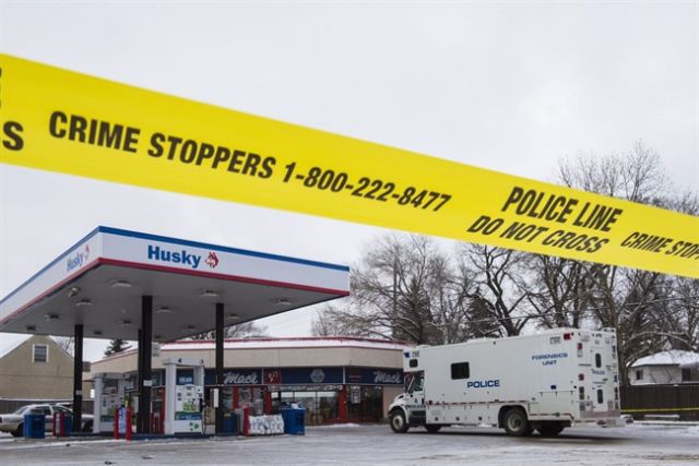 Homicide detectives investigate at a Mac's convenience store in Edmonton on Friday. THE CANADIAN PRESS  John Ulan