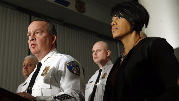 Baltimore police chief Kevin Davis left urges calm as he speaks at a press conference alongside mayor Stephanie Rawlings Blake following a mistrial in the case of William Porter one of six officers charged in connection with the death of Freddie Gray