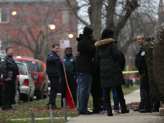 Police talk to neighbors at the Chicaco shooting scene. /USA TODAY