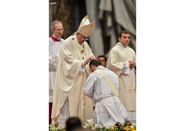 Pope Francis ordains a priest in St. Peter’s Basilica on 26 April 2015.- AFP