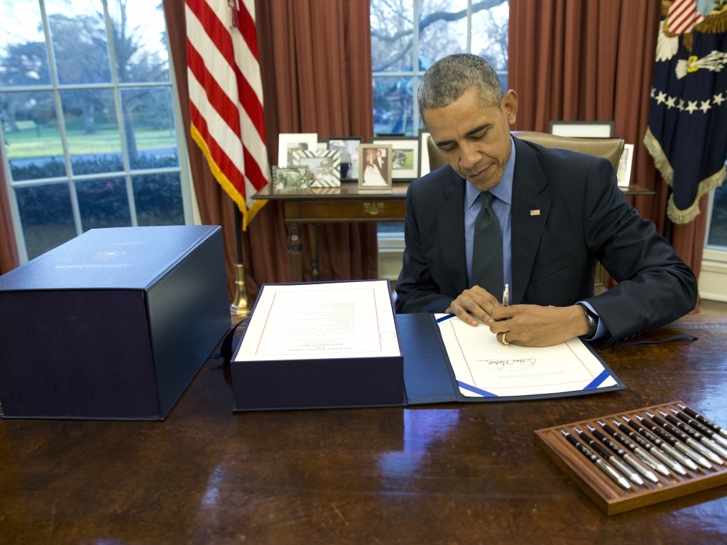 President Obama signs the budget bill in the Oval Office on Friday