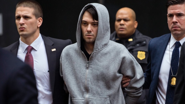 Martin Shkreli is escorted by law enforcement agents in New York Thursday Dec. 17 2015 after being taken into custody following a securities probe