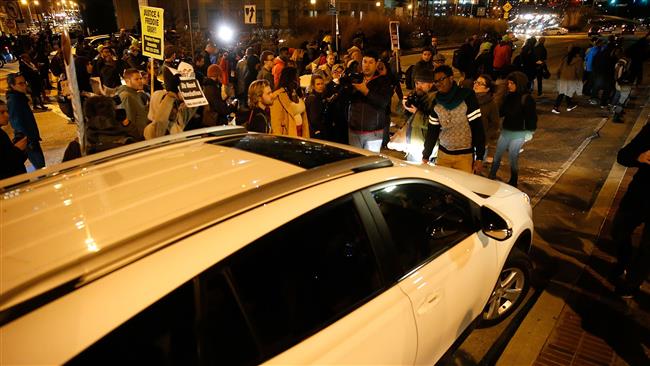 Protesters surround a car while marching through the streets after a mistrial was declared in the trial of Baltimore police Officer William G. Porter