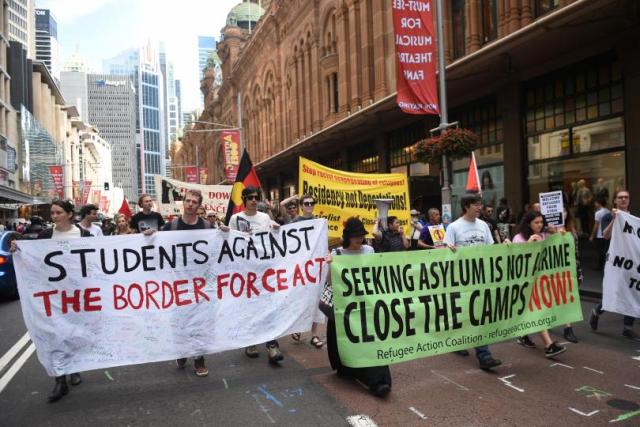 Protesters march in support of migrant refugees at a rally in Sydney Australia on Sept. 12 2015. AFP