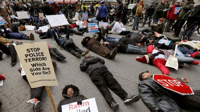 Protesters block an intersection on Chicago's Magnificent Mile calling for the resignation of Mayor Rahm Emanuel Thursday Dec. 24 2015 in Chicago