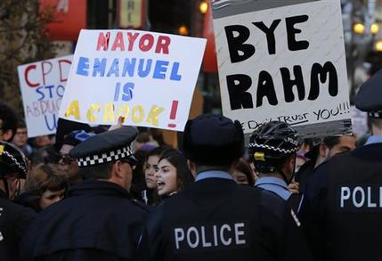 Protesters engage Chicago police officers during a march calling for Chicago Mayor Rahm Emanuel and Cook County State's Attorney Anita Alvarez to resign