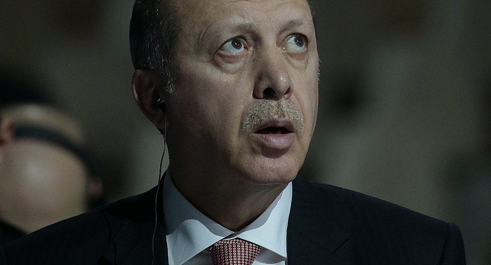 Turkish President Recep Tayyip Erdogan reacts as he attends the COP 21 United Nations conference on climate change