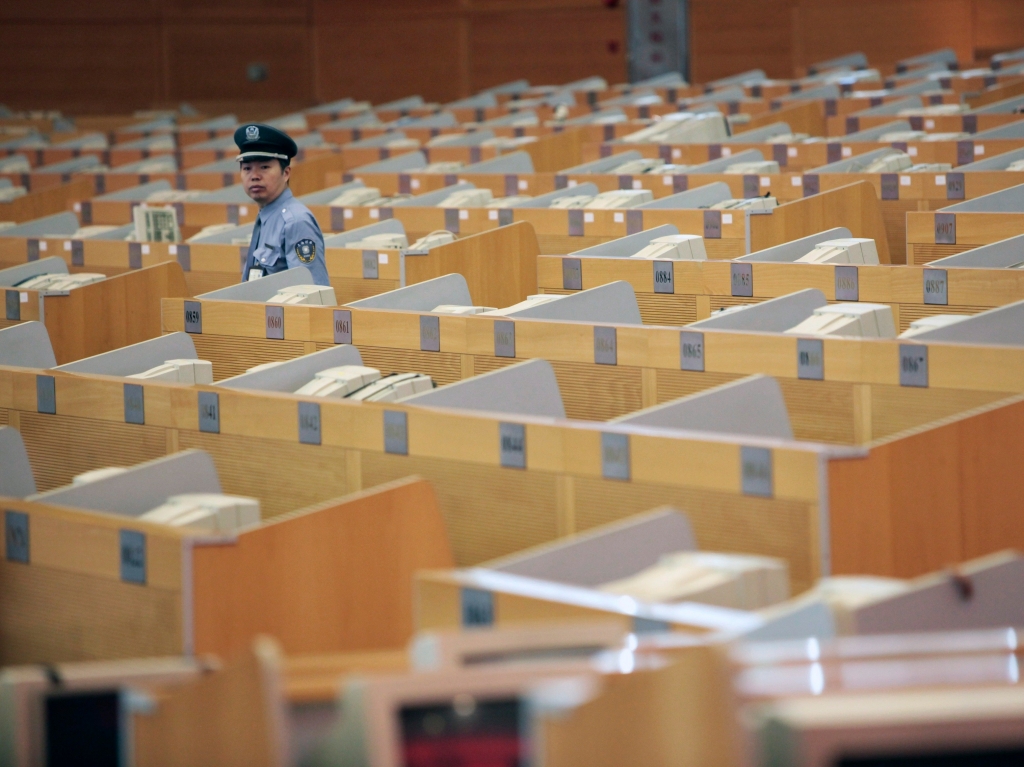 A security guard works at the Shanghai Stock Exchange in Lujiazui Financial Area in Shanghai