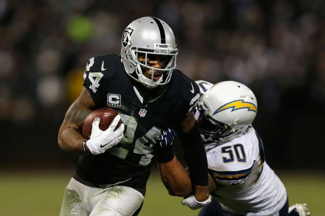 Safety Charles Woodson of the Oakland Raiders is tackled by linebacker Manti Te'o of the San Diego Chargers in the 4th quarter