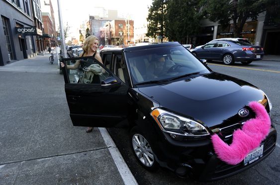 Katie Baranyuk gets out of a car driven by Dara Jenkins a driver for the ride-sharing service Lyft after getting a ride to downtown Seattle. Seattle may soon become the first city to let drivers of ride-h