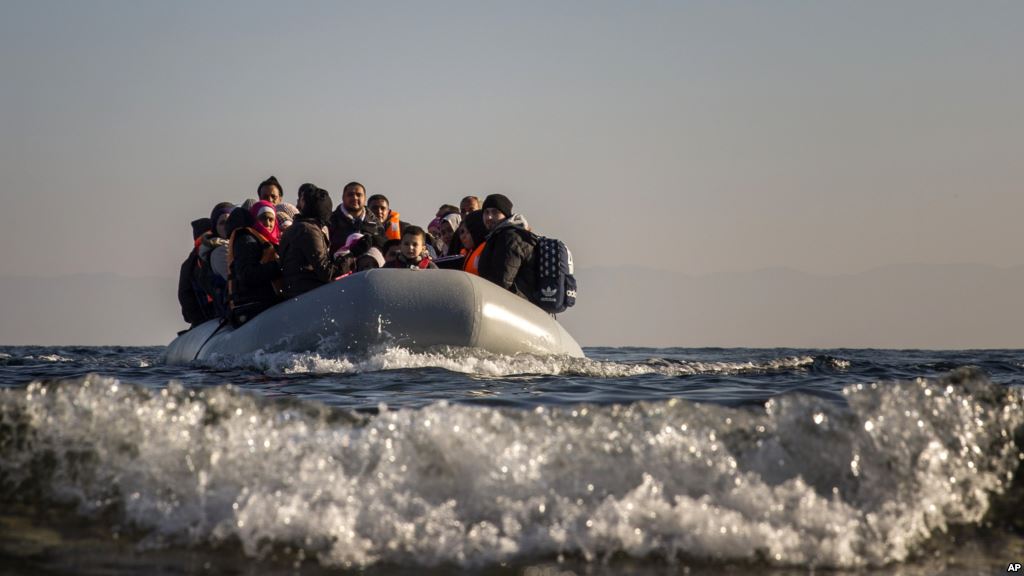 Refugees and migrants approach the Greek island of Lesbos on a dinghy after crossing the Aegean sea from the Turkish coast on Monday Dec. 7 2015