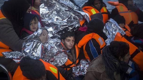 Refugees and migrants arrive on the Greek island of Lesbos after being rescued from the Aegean