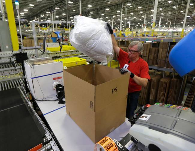 Mark Oldenburg packs a pair of pillows into a box for shipment to a customer Monday Nov. 30 2015