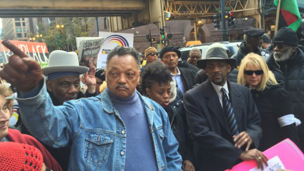 Rev. Jesse Jackson leads a protest march down State Street